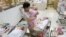 FILE - A nurse looks after babies inside the maternity ward of a hospital in Taipei, Oct. 25, 2011. 