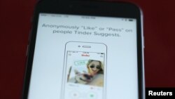 FILE - The dating app Tinder is shown on an Apple iPhone in this photo illustration.