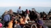 FILE—Migrants, mainly from sub-Saharan Africa, are stopped by Tunisian Maritime National Guard at sea during an attempt to get to Italy, near the coast of Sfax, Tunisia, April 18, 2023