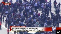 Gambar diambil dari video NBC TV Local10 menunjukan orang-orang berdiri di luar setelah insiden penembakan di bandara internasional Fort Lauderdale, Florida.