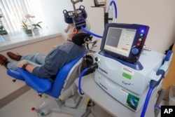 FILE - A patient receives a transcranial magnetic stimulation treatment for depression at the VA Palo Alto Health Care System, Nov. 7, 2018, Palo Alto, Calif.