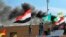 Smoke rises after pro-Iranian militiamen and their supporters set a fire in front of the U.S. embassy in Baghdad, Iraq, Jan. 1, 2020.