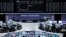 Traders at their desks in front of the DAX board at the Frankfurt stock exchange, Aug. 14, 2014.