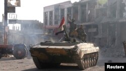 Syrian troops roll into the center of Qusair June 5, 2013, after capturing the stragegic town with key help from Lebanese Hezbollah fighters.