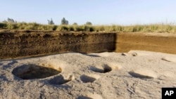 This undated photo released by the Egyptian Ministry of Antiquities, shows one of the oldest villages ever found in the Nile Delta, with remains dating back to before the pharaohs in Tell el-Samara, about 140 kilometers (87 miles) north of Cairo, Egypt. Chief archaeologist Frederic Gio says his team found silos containing animal bones and food, indicating human habitation as early as 5,000 B.C. 