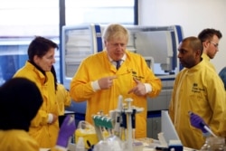 Britain's Prime Minister Boris Johnson visits a laboratory at the Public Health England National Infection Service, after more than 10 new coronavirus patients were identified in England, in Colindale, north London, March 1, 2020.