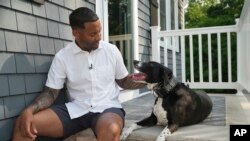 Dave Crenshaw poses for a photo with his service dog, Doc, in front of his home in Kearny, N.J., on Monday, June 3, 2024.