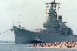 FILE - The battleship USS Missouri, 'Mighty Mo', looms over a gathering of fans as it returns to Pearl Harbor, June 22. 1998.