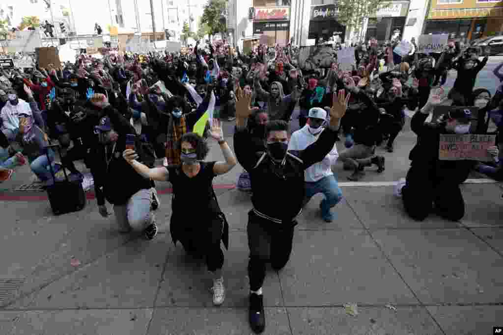 People kneel in front of the Hall of Justice in San Francisco, May 31, 2020, at protests over the Memorial Day death of George Floyd. 