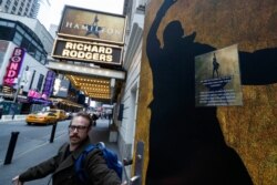 Theatre personnel leave the Richard Rodgers theatre that is closed due to COVID-19 concerns in Times Square in New York, March 12, 2020.