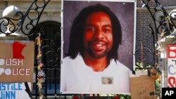 FILE - A memorial including a photo of Philando Castile adorns the gate to the governor's residence in St. Paul, Minn.