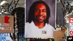 FILE - A memorial including a photo of Philando Castile adorns the gate to the governor's residence, July 25, 2016, where protesters demonstrated in St. Paul, Minn., against the July 6 shooting death of Castile by police officer Jeronimo Yanez. 