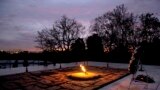 The eternal flame flickers in the early morning light at the grave of John F. Kennedy at Arlington National Cemetery on the 50th anniversary of Kennedy&#39;s death.