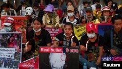 People gather during a candlelight vigil to protest against the military coup in Yangon, Myanmar, Feb. 21, 2021. 