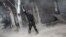 A rebel fighter is seen after he fired a shoulder-fired missile toward a building where Syrian troops loyal to President Bashar al-Assad were, Aleppo, Syria, November 4, 2012.