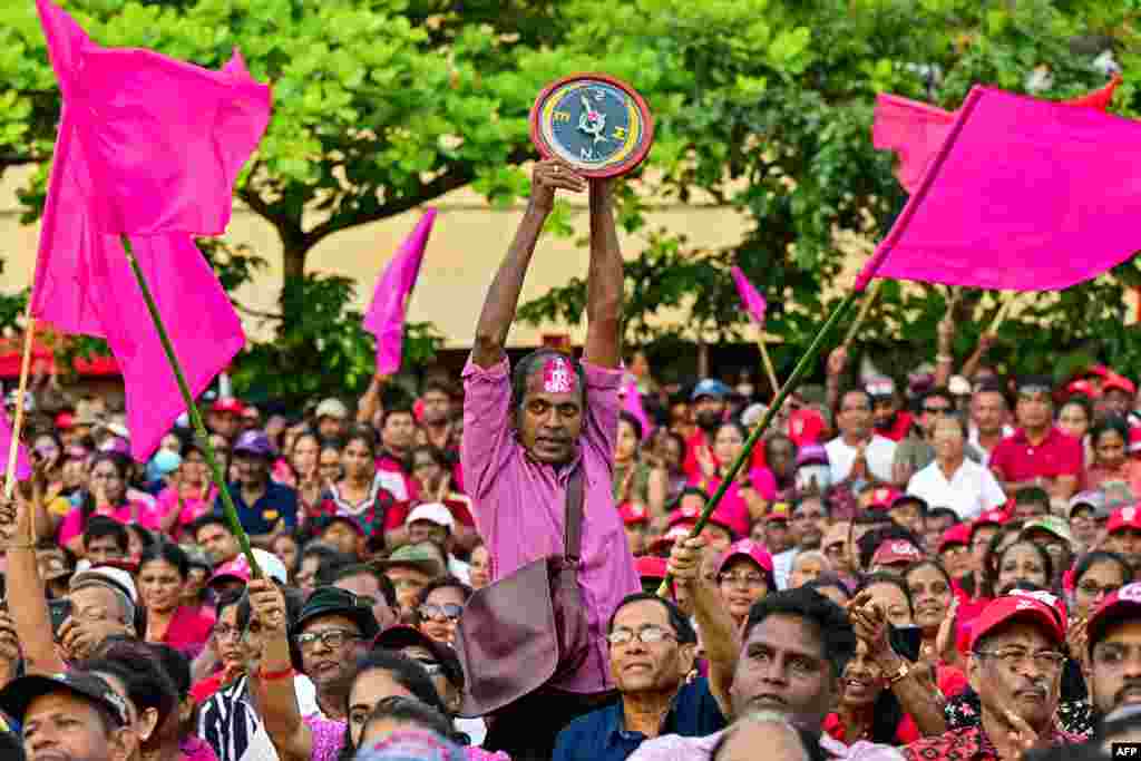 A supporter of National People&#39;s Power (NPP) presidential candidate Anura Kumara Dissanayaka, holds the party symbol during a rally ahead of the upcoming presidential elections in Colombo.