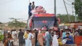 FILE - Afghan refugees board a bus from Karachi, Pakistan, to Afghanistan on Sept. 21, 2023. Afghans have poured into Pakistan by the millions during decades of successive wars. Pakistani officials on Oct. 3, 2023, ordered undocumented immigrants to leave the country by Nov. 1.