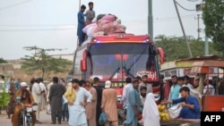 FILE - Afghan refugees board a bus from Karachi, Pakistan, to Afghanistan on Sept. 21, 2023. Afghans have poured into Pakistan by the millions during decades of wars. Pakistan on Oct. 3 ordered undocumented immigrants to leave the country by Nov. 1.
