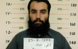 FILE - This handout photo taken Oct. 15, 2014 by the Afghan National Directorate of Security shows Taliban prisoner Anas Haqqani, a senior leader of the Haqqani network, in Kabul.