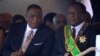 Zimbabwean President Emmerson Mnangagwa right, sits with his Deputy Constantino Chiwenga during a Heroes' Day event to commemorate the lives of those who died in the southern African country's 1970s war against white minority rule, in Harare, Aug. 13, 201