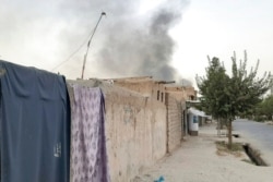 Smoke rises from the city of Lashkar Gah after airstrikes against Taliban in Helmand province southern of Kabul, Afghanistan, Aug. 6, 2021.