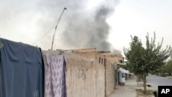 FILE - Smoke rises from the city of Lashkar Gah after airstrikes against Taliban in Helmand province southern of Kabul, Afghanistan, Aug. 6, 2021.