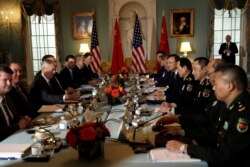 FILE - U.S. and Chinese officials are seen meeting during the second bilateral Diplomatic and Security Dialogue, at the State Department in Washington, Nov. 9, 2018.