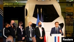 French President Emmanuel Macron speaks in front of a life-size replica of the next TGV high-speed train at the Gare de Lyon station, in Paris, Sept.17, 2021.