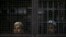 FILE - Rohingya Muslim illegal immigrants look out from the Immigration Detention Center in Kanchanaburi province, Thailand, July 10, 2013.