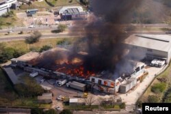 A general view of a burning warehouse after violence erupted following the jailing of former South African President Jacob Zuma, in Durban, July 14, 2021.