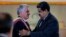 Cuba's President Miguel DIaz-Canel, left, is embraced by his Venezuelan counterpart Nicolas Maduro after being awarded the "Orden del Libertador Simon Bolivar," at Miraflores Presidential Palace in Caracas, Venezuela, May 30, 2018. 