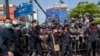 FILE - Police move to strengthen barriers with pro-democracy protesters during a rally, Dec. 10, 2020 in Bangkok, Thailand.