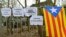 An Estelada (Catalan separatist flag) is seen next to slogans in front of the prison in Neumuenster, Germany, March 26, 2018. The signs read "Freedom for Carles Puigdemont," "Free Our President" and "Free Political Prisoners."