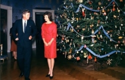 President John F. Kennedy and first lady Jaqueline Kennedy are see standing next to the White House Christmas tree in a picture taken during the 1961 holiday season. (Source - John F. Kennedy Presidential Library)