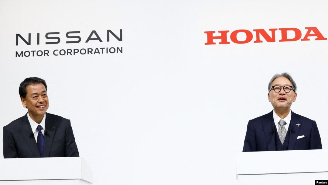 Makoto Uchida, director, representative executive officer, president and CEO of Nissan Motor Corporation, and Toshihiro Mibe, director, president and representative executive officer of Honda, react during a press conference on merger talks, in Tokyo, Japan, Dec. 23, 2024.