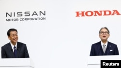 Makoto Uchida, director, representative executive officer, president and CEO of Nissan Motor Corporation, and Toshihiro Mibe, director, president and representative executive officer of Honda, react during a press conference on merger talks, in Tokyo, Japan, Dec. 23, 2024.