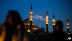 FILE —A message in lights is installed in between the minarets of the Suleymaniye mosque in Istanbul, Turkey, March 10, 2024.