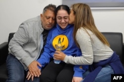 This handout picture released by the Israeli army shows former Israeli hostage Liri Albag reunited with family at an army screening point in Reim in southern Israel, Jan. 25, 2025.