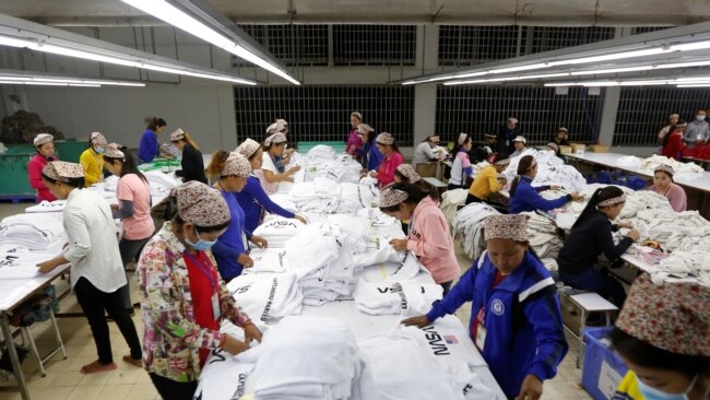 FILE - Employees work at a garment factory, a supplier for the H&M brand, in Kandal province, Cambodia, Dec. 12, 2018.