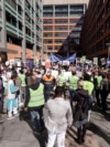 FILE - Hundreds of protesters rally outside the Immigration Department offices in Sydney, Australia, Aug. 12, 2019. The protest was to highlight the uncertain futures of many refugees since Australia had replaced permanent protection visas with temporary visas. 