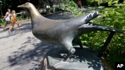 FILE - A statue of Martha, the last passenger pigeon, stands at the Cincinnati Zoo in Cincinnati, Ohio, July 18, 2013. Martha died on Sept. 1, 1914, at the reported age of 29.