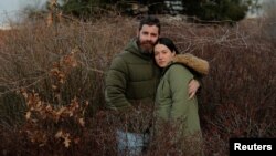 Jenny Ostrom, 37, a director of photography, and her husband Chad Ostrom, 37, a director, stand in McCarren Park, near their home in the Brooklyn borough of New York, Feb. 8, 2018.