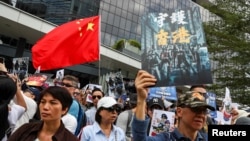 People hold a China national flag and signs as they participate in a pro-government rally to show their support for the police and government in Hong Kong.