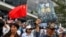 People hold a China national flag and signs as they participate in a pro-government rally to show their support for the police and government in Hong Kong.