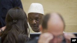 Congolese warlord Thomas Lubanga (C) speaks to his lawyers in the courtroom of the International Criminal Court where he was found guilty of war crimes for recruiting and deploying child soldiers during a five-year conflict until 2003, in The Hague, March