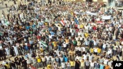 Demonstrators protesting against Syria's President Bashar al-Assad march through the streets after Friday prayers in Homs, October 7, 2011.