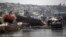Boats lifted by an earthquake-triggered tsunami sit on a dock in Coquimbo, Chile, Sept. 18, 2015. 