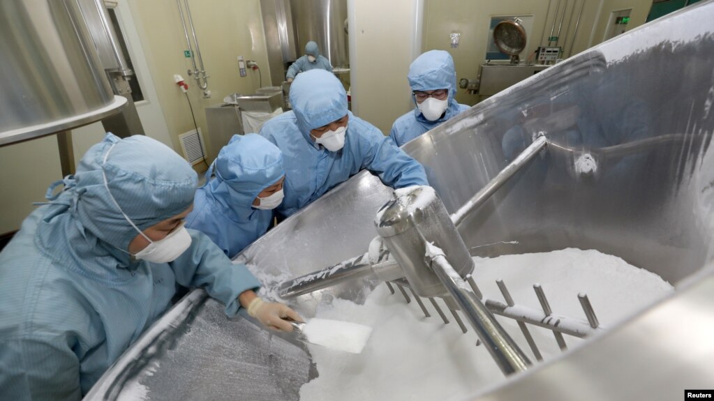 Employees work on the production line of an anti-malarial drug that Chinese officials said has curative effect on the novel coronavirus disease, at a pharmaceutical company in Nantong, Jiangsu province, China Feb. 27, 2020. 