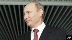 Russian Prime Minister Vladimir Putin gestures while speaking to journalists in Moscow, April 13, 2011
