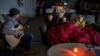 Brett Archibad, whose home was without electric power following winter weather, entertains his family as they try to stay warm in their home the BlackHawk neighborhood in Pflugerville, Texas, Feb. 16, 2021. (Ricardo B. Brazziell/via Reuters) 